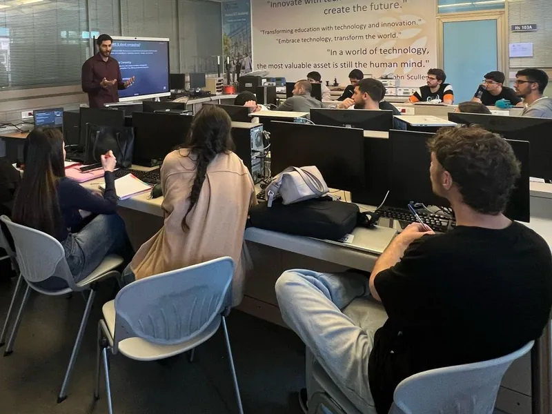 Elio lecturing on AWS and cloud computing to a full computer lab.