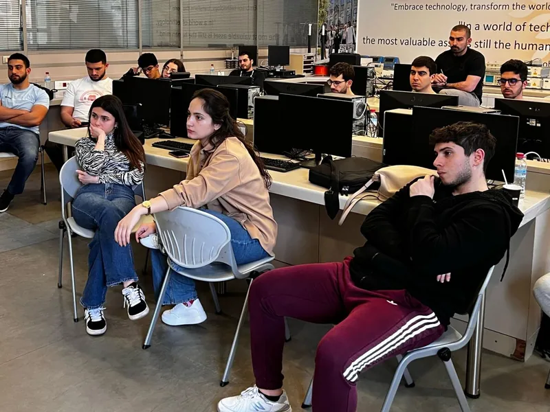 Students seated across the Huawei ICT Academy lab at USEK, listening during a session.